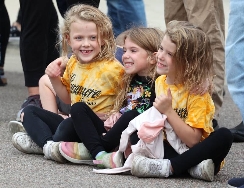 Vienna Coovert, (left) 6, Claire Aguilera, 5, and Isabelle Coovert,(right) 6, from Sycamore wait for the Sycamore High School homecoming parade to start Wednesday, Sept. 20, 2023, on State Street in Sycamore.