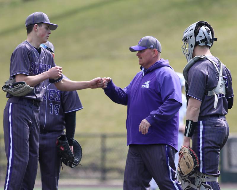 Dixon's head coach Jason Burgess relieves Alex Harrison (1) during baseball game between Dixon at Hampshire.  March 28, 2024