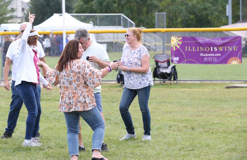 People dance while enjoying wine at the 20th annual Vintage Illinois Wine Festival on Sunday, Sept. 17, 2023 in Utica.
