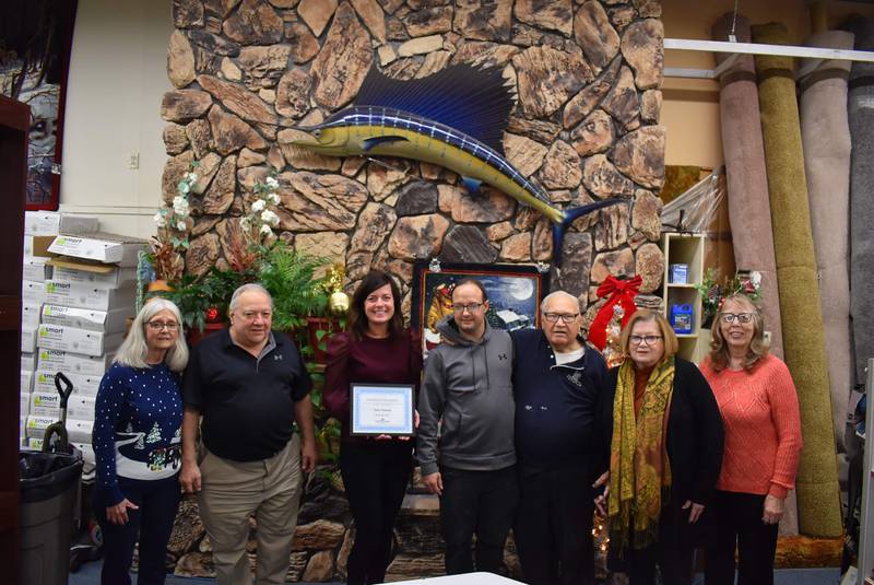 (From left) Diana Parcher, Rick Yuhas, Courtney Levy, Streator Chamber executive director; Ryan Yuhas, Dick Yuhas, Peggy Flahaut and Judy Booze, Chamber ambassador take part in Dick's Floor Covering's recognition as November 2023 Streator Chamber Business of the Month.