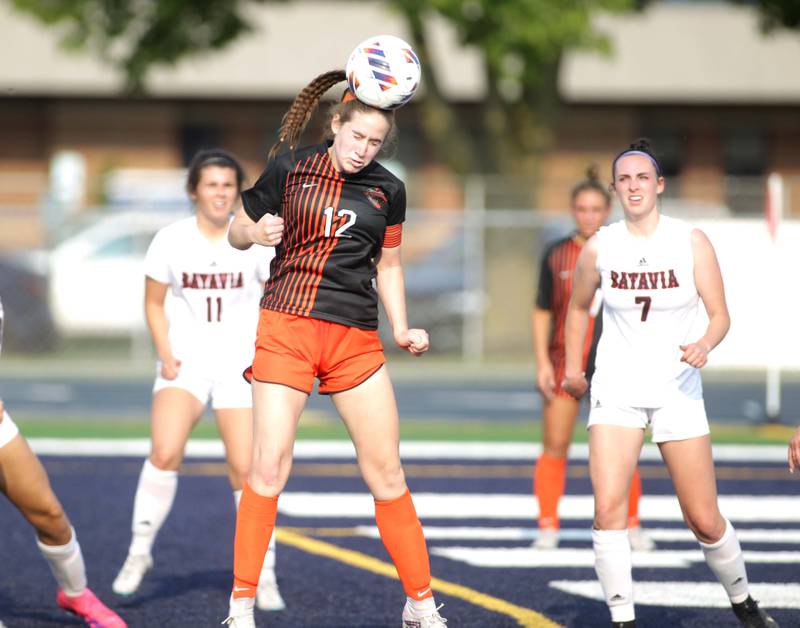 St. Charles East’s Amanda Stepien heads the ball during a Class 3A West Chicago Sectional semifinal win over Batavia on Tuesday, May 23, 2023.