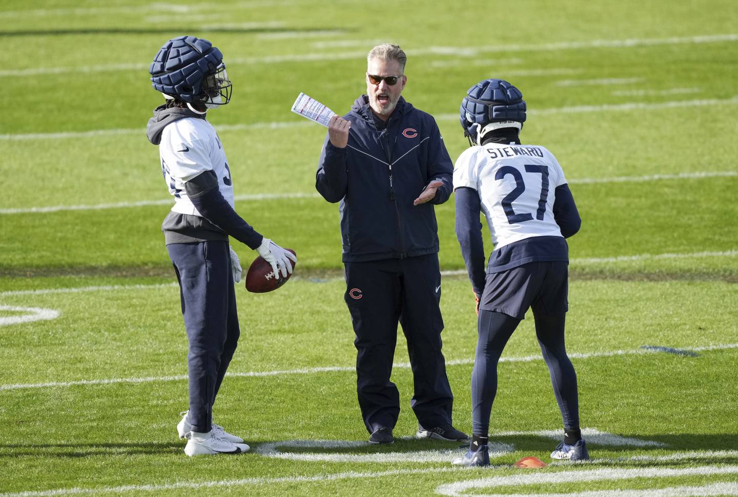 Chicago Bears head coach Matt Eberflus talks to Chicago Bears corner back Reddy Steward (27) during a training session in Ware, England, Thursday, Oct. 10, 2024, ahead of the game between the Chicago Bears and the Jacksonville Jaguars at Tottenham Hotspur Stadium on Sunday. (AP Photo/Sean Ryan)