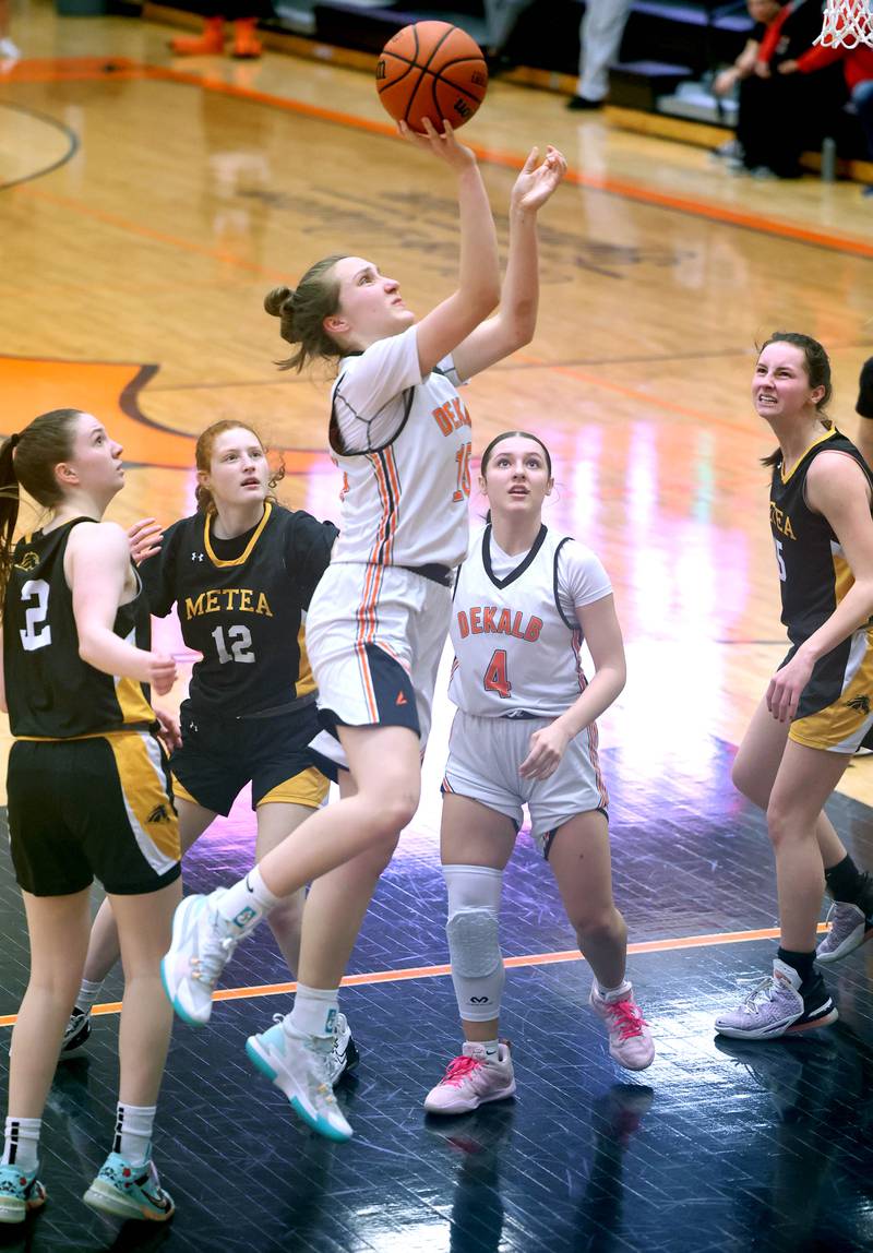 DeKalb's Kailey Porter splits two Metea Valley defenders for a layup during their game Thursday, Jan. 19, 2023, at DeKalb High School.