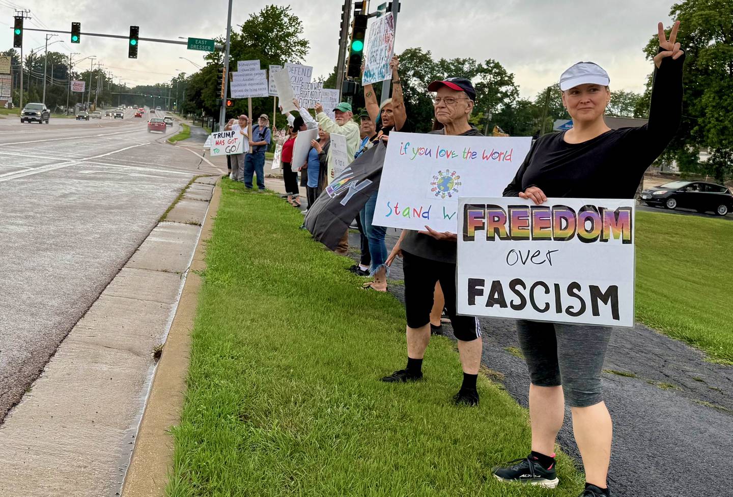 Protestors gather on Saturday, July 19, 2025, along Sycamore Road in Hopkins Park in DeKalb for a "Good Troubles Lives On" demonstration, one of thousands organized this week to honor the life and legacy of the late U.S. Rep. John Lewis. Though the official event was canceled due to weather Saturday, many still showed up to protest actions taken by President Donald Trump and his administration.