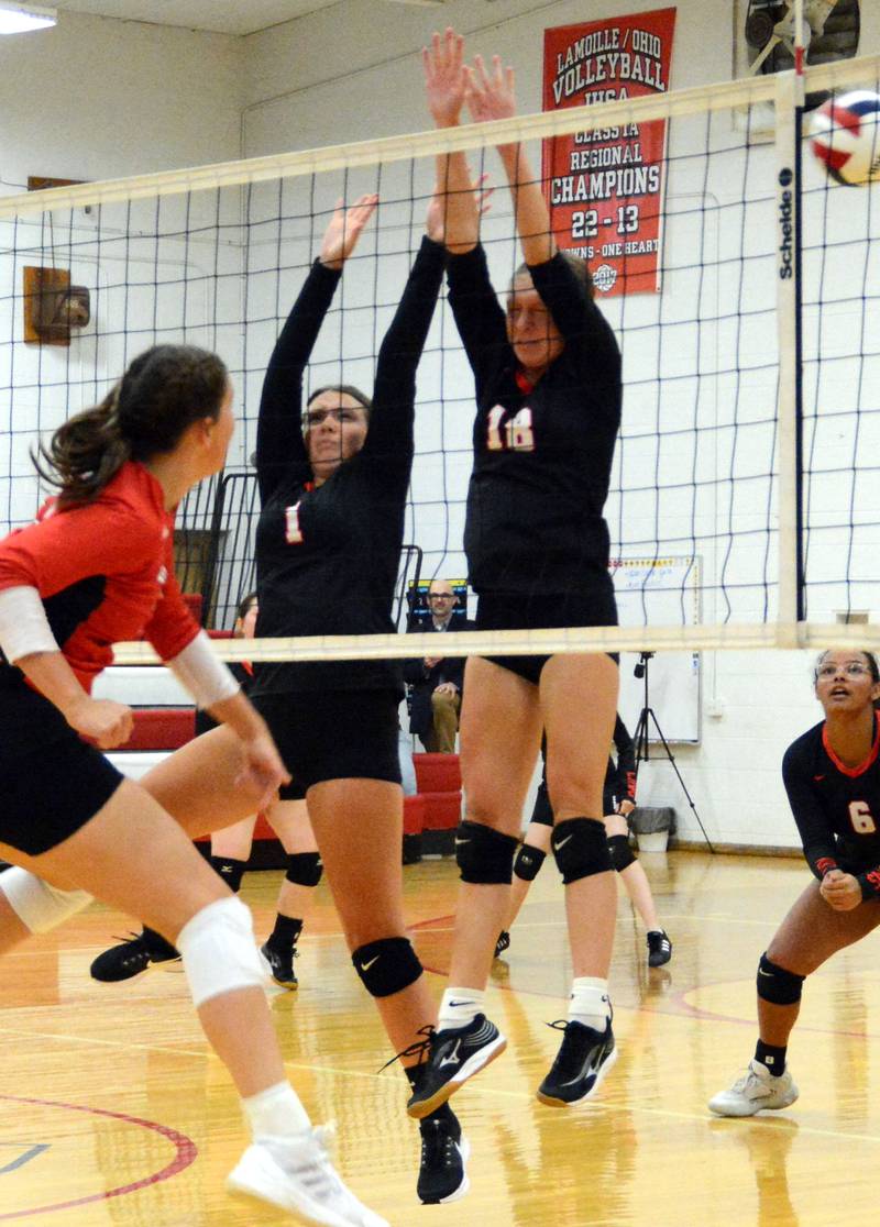 LaMoille's Grace Kellly and Ella Ryan defend the net against Henry-Senachwine in Tuesday's match at LaMoille.
