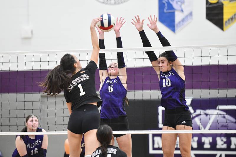 Wilmington's Maggie Lindsey, left, and Rachel Smith jump to block Tuesday during the Wildcats victory in two sets over Chicago University in the IHSA Class 2A Manteno Sectional semifinal.
