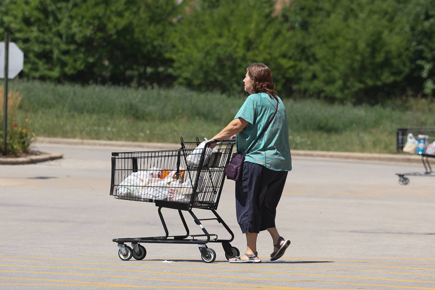 A shopper leaves a local supermarket pushing a few bags in her cart. The annual inflation rate for the United State was 9.1% at the end of June, the largest annual increase since November 1981. Friday, July 22, 2022 in Joliet.