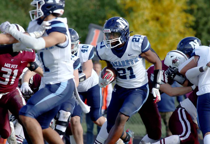 Nazareth’s Lesroy Tittle moves the ball against Prairie Ridge in first-round Class 5A playoff football action at Crystal Lake Saturday.