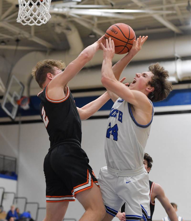 Wheaton Warrenville South Jake Vozza (2) fouls St. Charles North's Colin Ross (24) during a game on Friday, December 2, 2022.