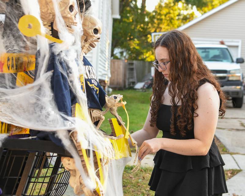Sycamore High School senior Claire puts the finishing touches on the Key Club golf cart before the start of the Homecoming parade on Wednesday, Oct. 8, 2025, in downtown Sycamore.