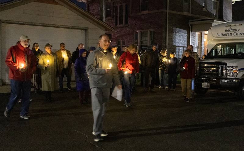 Locals gather with area faith leaders to walk from Shannon Hall to the Peace on Earth Bridge in Batavia as part of an International Peace Vigil on Sunday, Nov. 23, 2025.