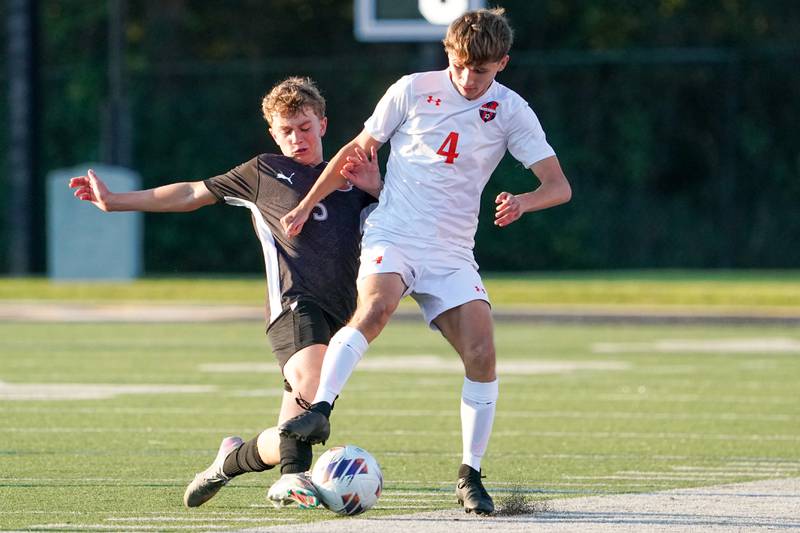 Wheaton Warrenville South's Will Freeding (5) challenges Oswego’s Nathan Wentzell (4) for the ball during a soccer match at Wheaton Warrenville South in Wheaton on Thursday, Aug 28, 2025.