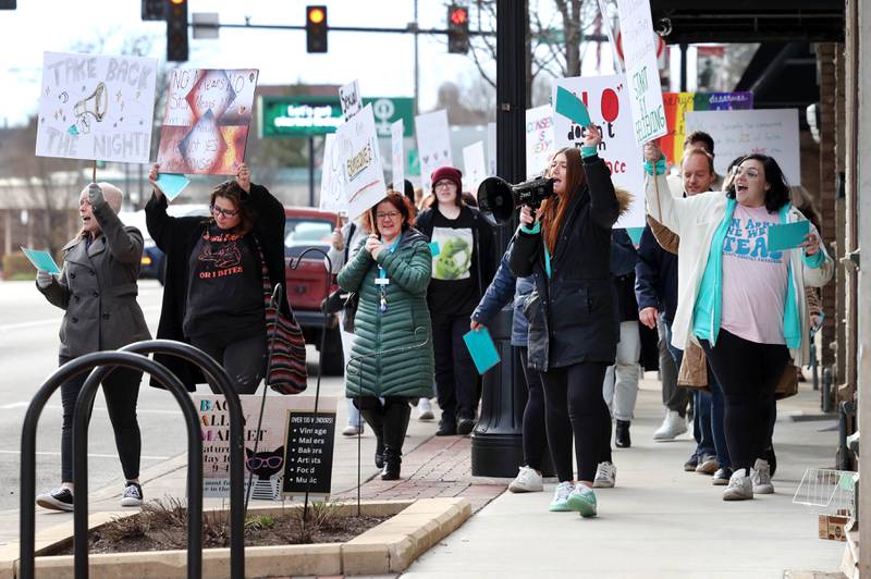 Marchers cheer as vehicles honk their horns on Lincoln Highway Monday, April 7, 2025, during the Safe Passage Take Back the Night and Survivor Speak Out in Dekalb. The event is held in conjunction with Sexual Assault Awareness Month.