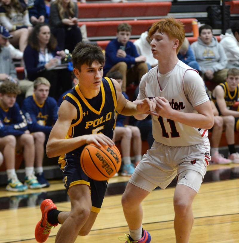 Polo's Gus Mumford (5) drives the baseline as Forreston's Connor Politsch (11) defends  on Tuesday, Jan. 7, 2024 at Forreston High School.
