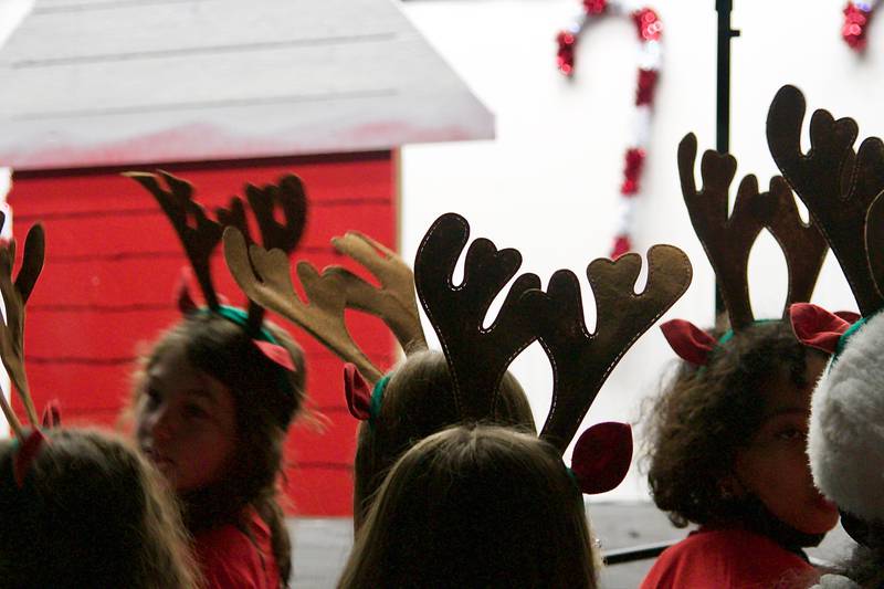 The Traughber Junior High School choir members, adorned with reindeer antlers, sang holiday tunes  during Oswego's Christmas tree lighting ceremony Dec. 3.