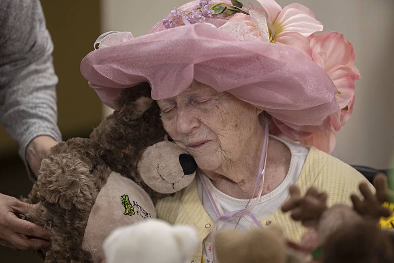 Heritage Woods resident Margie Mathias gives a hug to a Teddy bear gifted to her from the staff at the Sterling nursing home Friday, March 31, 2023. Mathias, a popular person with staff and residents alike, is rarely seen without one of her stuffed buddies. In honor of Mathias, her friends threw her a Teddy bear tea party, complete with stylish hats, snacks, different teas and, of course, Teddy bears.