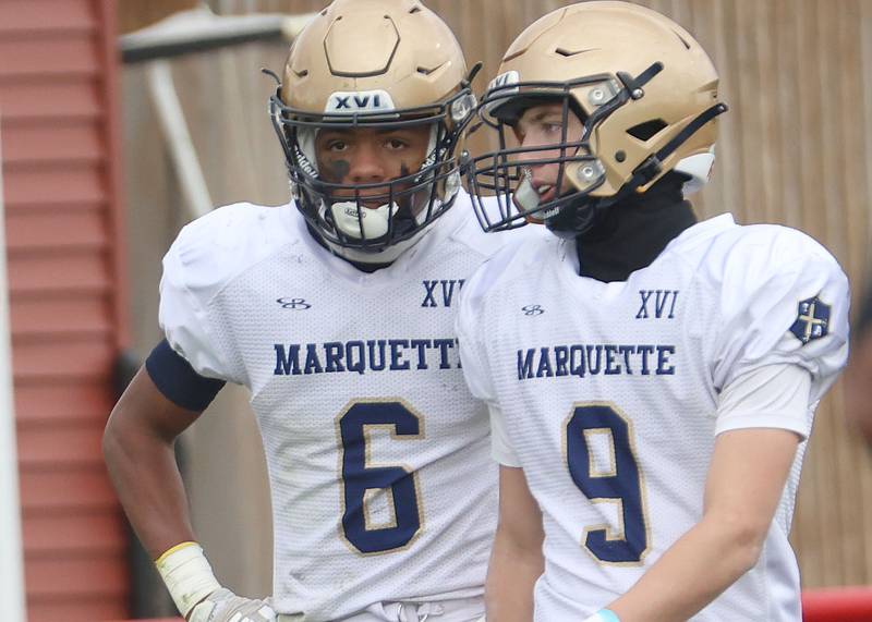 Marquette's Connor Baker chats with teammate Easton Debernardi after Gibson City-Melvin-Sibley scored a touchdown during the Class 1A playoff game on Saturday, Nov. 1, 2025 at Gibson City-Melvin-Sibley High School.