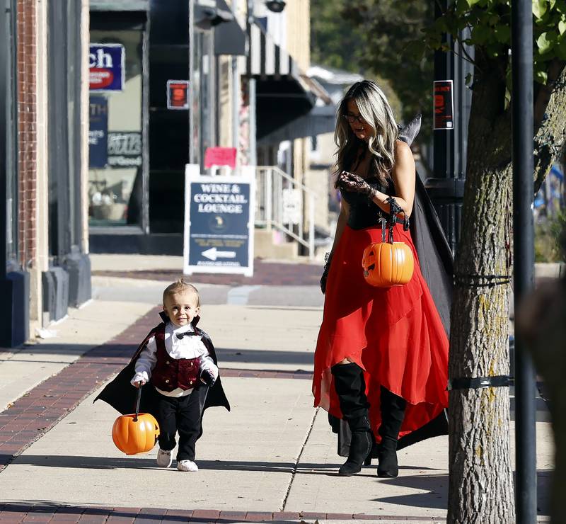 Jen Tokar of Inverness with her son Paul Tokar, 2, trick-or-treat Thursday, Oct. 30, 2025 in Geneva.