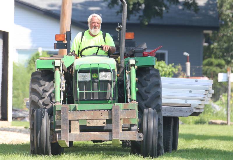 Dave Mead volunteer, moves tables to different barns on a tractor to set up for the 168th annual Bureau County Fair on Tuesday, Aug. 22, 2023 in Princeton.
