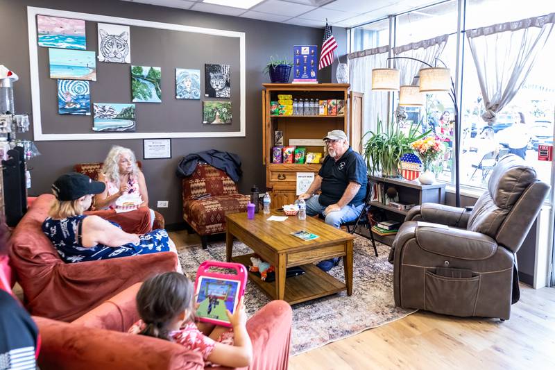 Folks enjoy the living room during AllenForce's grand opening event which introduced the community to the new Veteran Wellness & Recreation Center in Joliet on July 25, 2025.