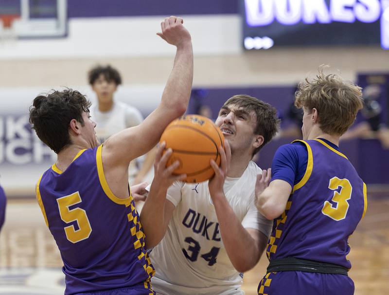 Dixon’s Jakob Nicklaus work below the basket against Sherrad’s Jackson Jones (left) and Ryder Veronda Friday, Feb. 20, 2026.