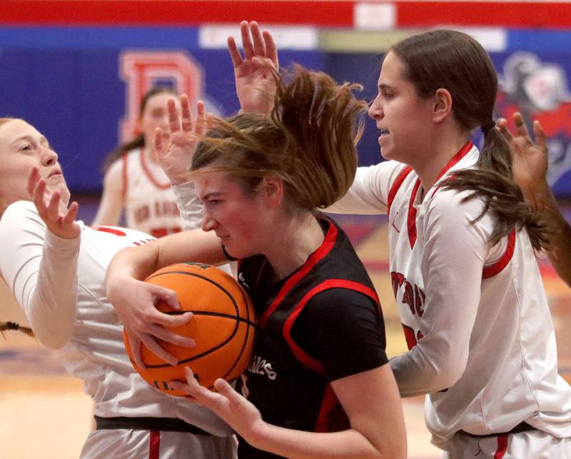 Huntley’s Alyssa Borzych, right, and Avery Suess, left, pressure Mundelein’s Madelyn Gardner in varsity girls basketball Komaromy Classic tournament  action on Tuesday, Dec. 30, 2025, at Dundee-Crown High School in Carpentersville.
