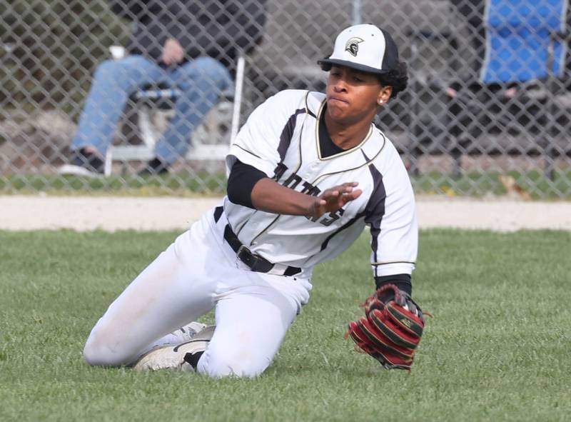 Sycamore's Tyler Townsend makes a sliding catch in left field during their game against Kaneland Monday, April 22, 2024, at the Sycamore Community Sports Complex.