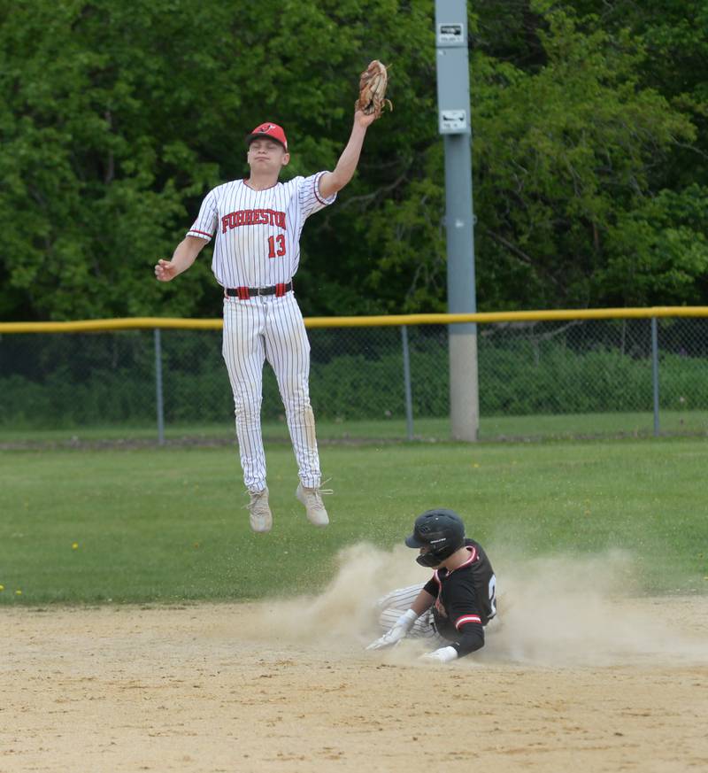 Forreston's Kendall Erdmann catches a high throw as Fulton's Caden Wilkin steals second at the 1A Amboy Regional on Saturday, May 24, 2025.