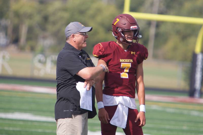 Richmond-Burton's Joe Miller talks strategy with Coach Mike Noll against Normal West on Saturday, Sept. 17,2022 in Richmond.