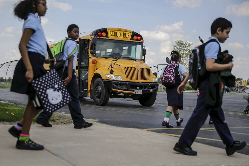 Students board buses Wednesday at Laraway Elementary School in Joliet.