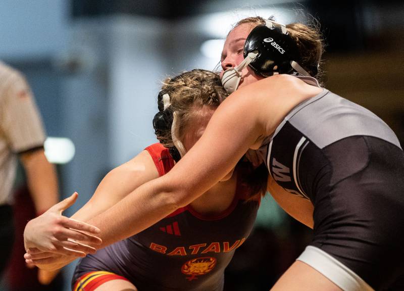 Lincoln Way’s Bailey Mitchell (right) grapples with Batavia’s Annabelle Guthke during a varsity wrestling dual at Batavia High School on Friday, Jan. 10, 2025.