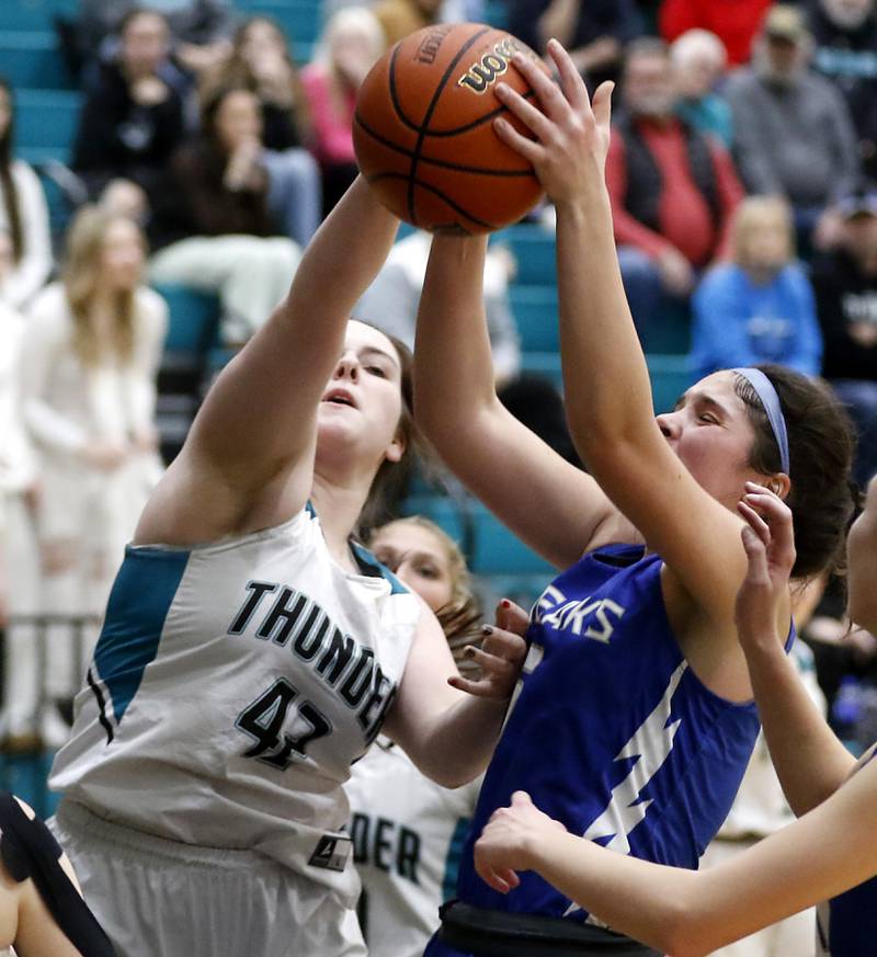 Woodstock's Natalie Morrow grabs a rebound in front of Woodstock North’s Brenna McConnell during a Kishwaukee River Conference girls basketball game on Friday, Jan. 5. 2024, at Woodstock North High School.