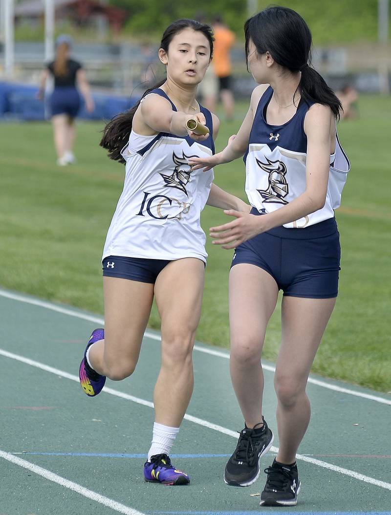 IC Catholic’s Sienna Azzinaro and Hayden James compete in the 4x800 meter relay during the Class 1A girls Sectional track meet on Thursday, May 11, 2023 at Seneca High School.