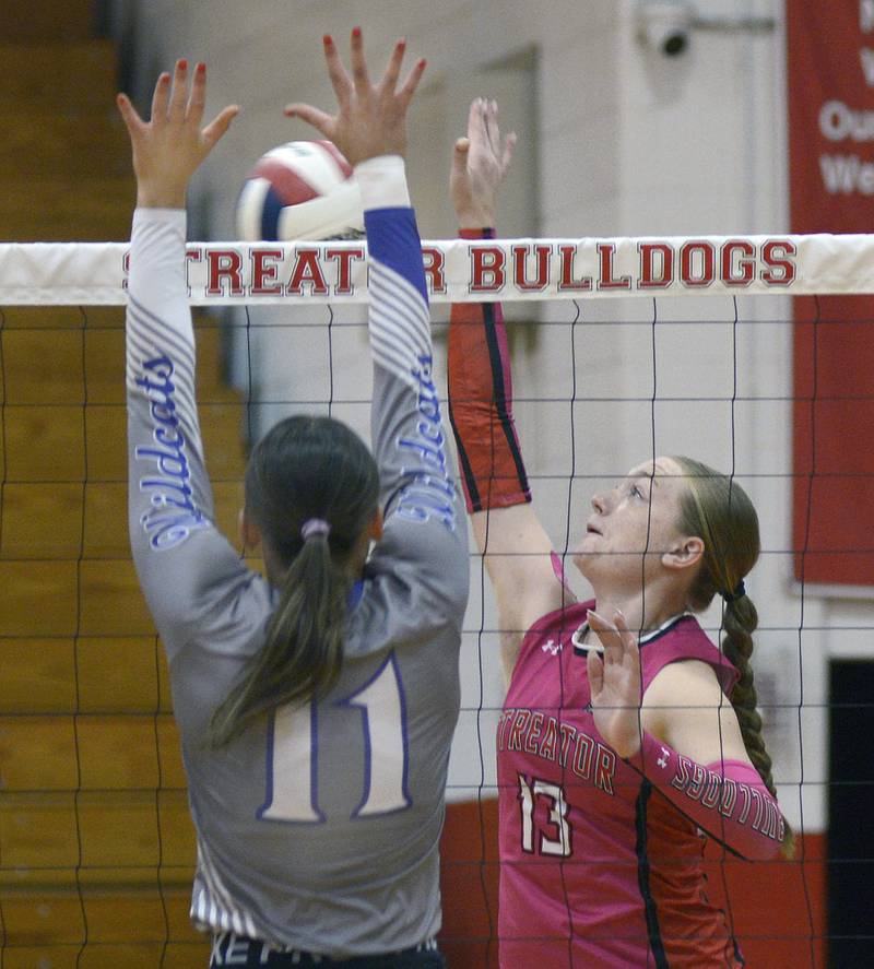 Streator’s Kinslee Sweeden sets to get past the block of Wilmington’s Molly Southall during the 1st set of Tuesday’s match at Streator.