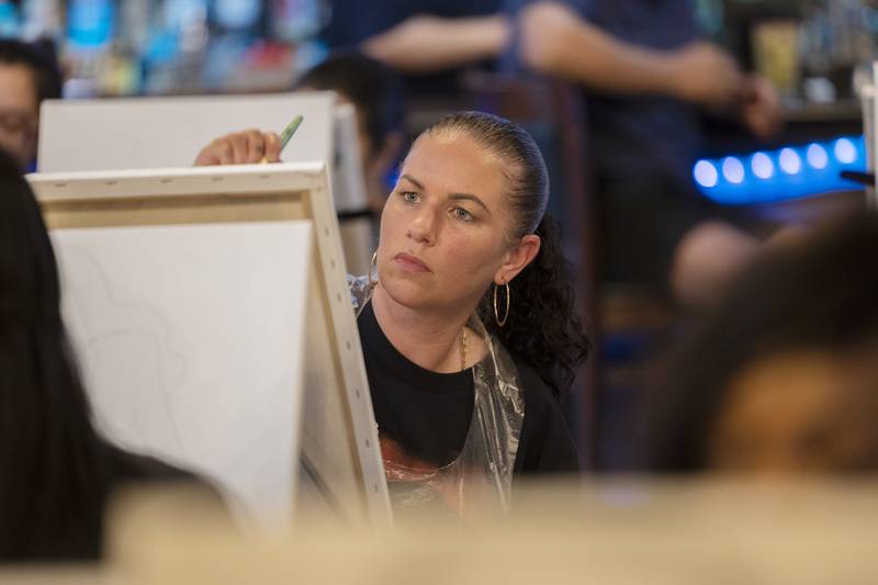 Ashleigh Chapman of Sterling eyes her work as she paints Monday, April 15, 2024. Selena was murdered by her fan club president on March 31, 1995.