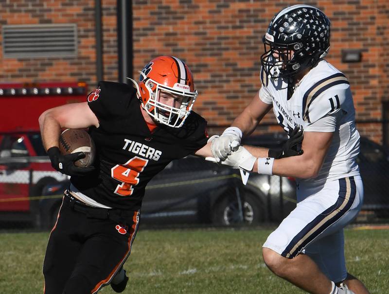 Byron's Dawson Criddle fights off IC Catholic's Grant Bowen during 3A quarterfinals at Byron High School on Saturday, Nov. 15, 2025. The Tigers won the game 28-6 to advance to the state semifinals.