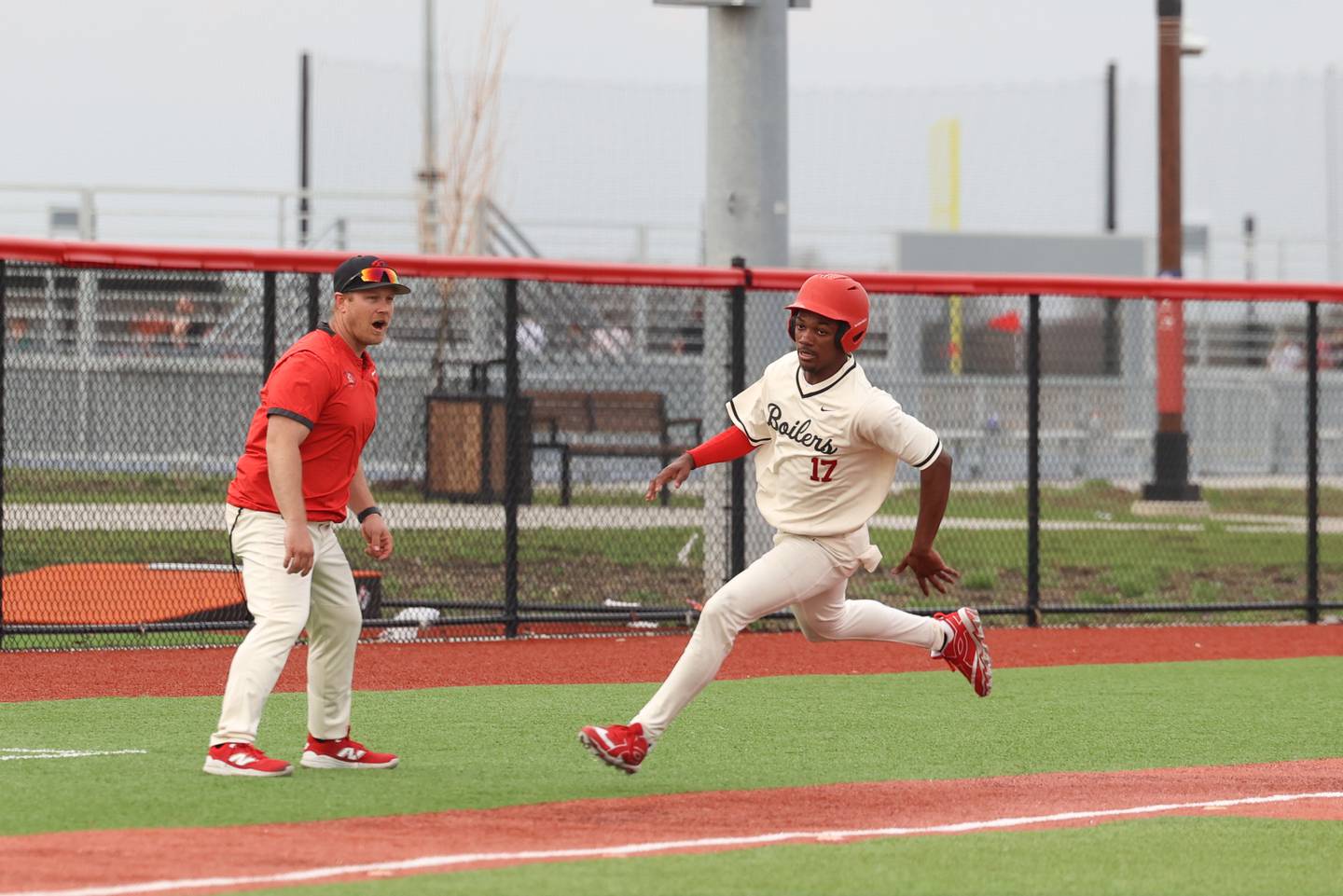 Bradley-Bourbonnais' Byron Sumrall rounds third base as coach Brad Schweigert sends him during the Boilermakers' 8-7 loss to Homewood-Flossmoor on Monday, April 13, 2026.
