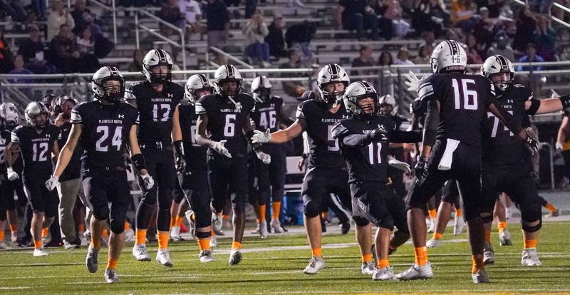 Plainfield North players celebrate after a last second interception by Plainfield North's Treycen Bownes (16) to secure a victory over Oswego at Plainfield North High School on Friday, Sept. 22, 2023.