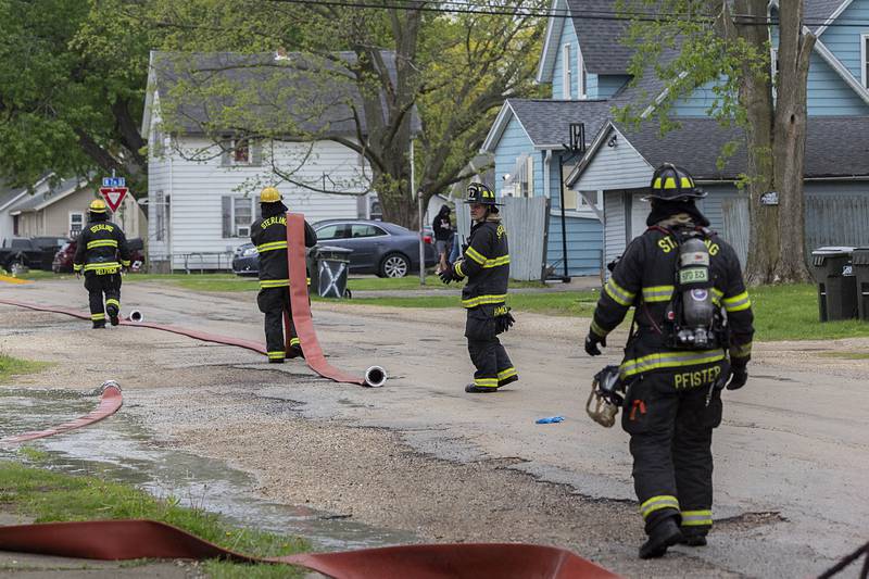Sterling firefighters begin to put away gear Monday, April 27, 2026, at the scene of a fire on Avenue I in Sterling.