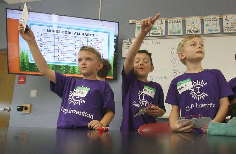 Students Wyatt, Davis, and Owen learn Morse Ccde while making transmitters during Inventor Camp on Friday, June 13, 2025, at Central Intermediate School in Ottawa.