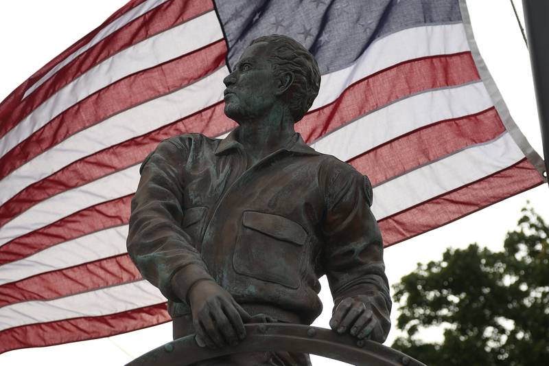 An American flag flies behind the Sator Sanches statue at the corner of Collins and Ohio Street on Friday, Sept. 27, 2024.
