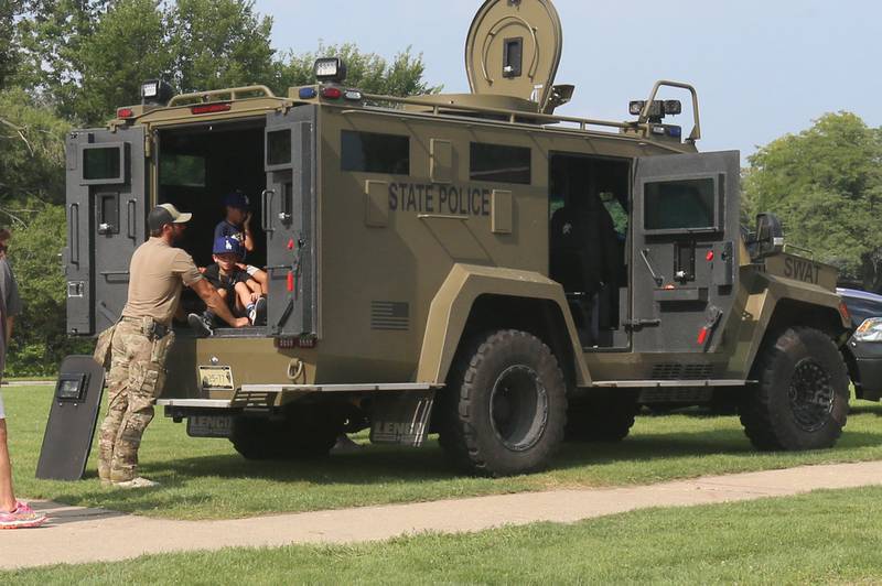 Kids check out the Illinois State Police Swat vehicle during National Night Out on Tuesday, Aug. 5, 2025 in Oglesby. Oglebsy Police, Fire and EMS along with Utica Fire, Illinois State Police and OSF Lifeflight helicopter also attended. The event featured food, foam machine, bounce house, games and more. National Night Out is an annual community policing campaign held on the first Tuesday of August to create police-community partnerships and build safer neighborhoods