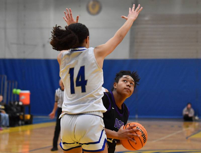 Downers Grove North’s Elizabeth Murphy peaks at the basket as Lyons Township’s Kennedy Moore (14) defends during a game on January 10, 2026 at Lyons Township High School in LaGrange.