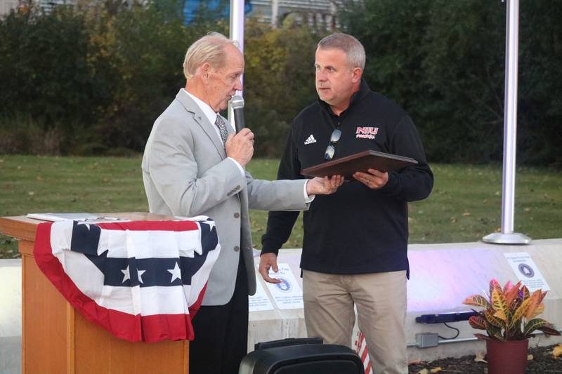 Local U.S. Air Force veteran and Michael Embrey (left) presents a plaque to DeKalb mayor Cohen Barnes at a rededication ceremony Oct. 20, 2023 for the DeKalb Veterans Memorial outside the DeKalb Elks Lodge in DeKalb.