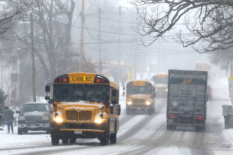School buses travel along Route 31 after leaving Nippersink Middle School on Thursday, Feb. 16, 2023, in Richmond, after a winter storm moved through McHenry County, creating hazardous driving conditions.