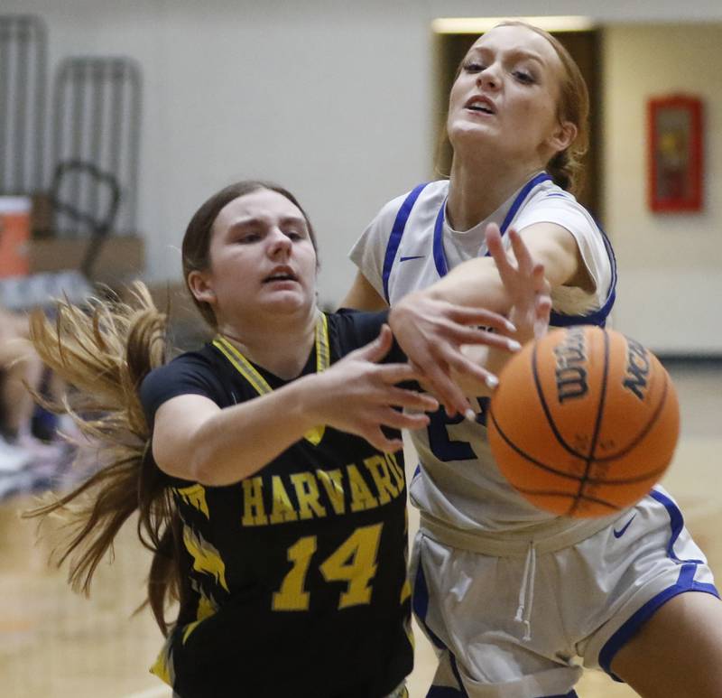 Harvard's Olivia Nulle has the ball knocked away by Woodstock's Aiyana Fourdyce during a Kishwaukee River Conference girls basketball game on Monday Jan. 12, 2026, at Woodstock High School.