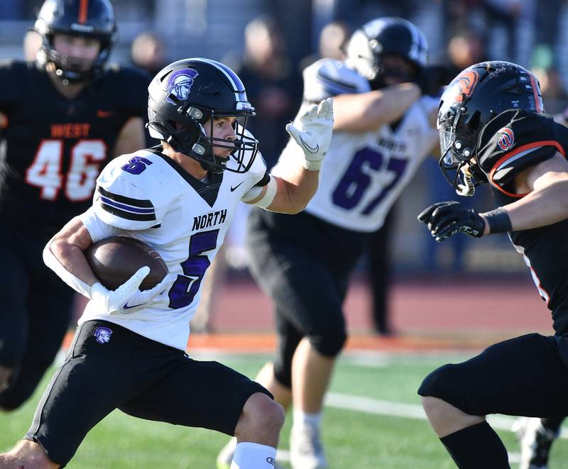 Downers Grove North's Owen Thulin (5) turns upfield after making a catch against Lincoln-Way West during an IHSA Class 7A quarterfinal game on Nov. 11, 2023 at Lincoln-Way West High School in New Lenox.