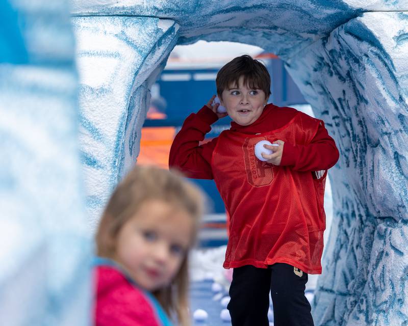 Kid looks to throw "snowball" at the annual 'Ax Church Ultimate Snowball Fight' at Frosty on First on Saturday, November 8, 2025 on First Street in La Salle.