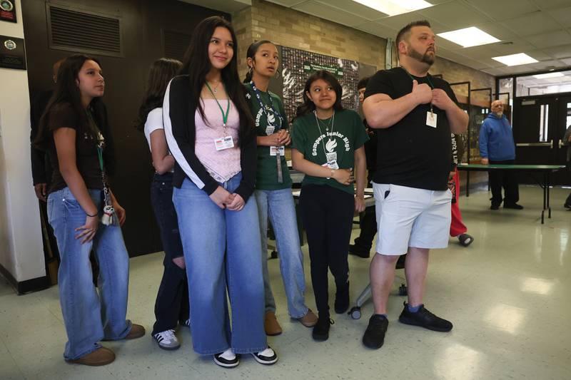 Grompers Junior High School teacher Chad Nelson stands with his students as a time capsule is removed from a wall on Wednesday, May 1, 2026 in Joliet. In 1969 students placed items in a time capsule and sealed it inside a wall when an extension was built at Grompers Junior High School.