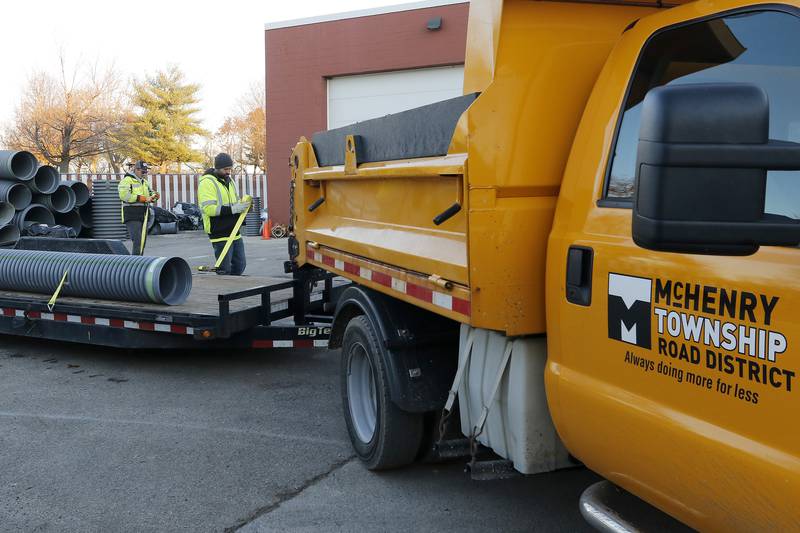 McHenry Township Road District maintenance worker Connor Solum, left, and crew lead Brandon McCoy load a culvert pipe onto a trailer to be delivered and installed at Hilltop Dr. on Thursday, Nov. 18, 2021 at the McHenry Township Roads District in Johnsburg.